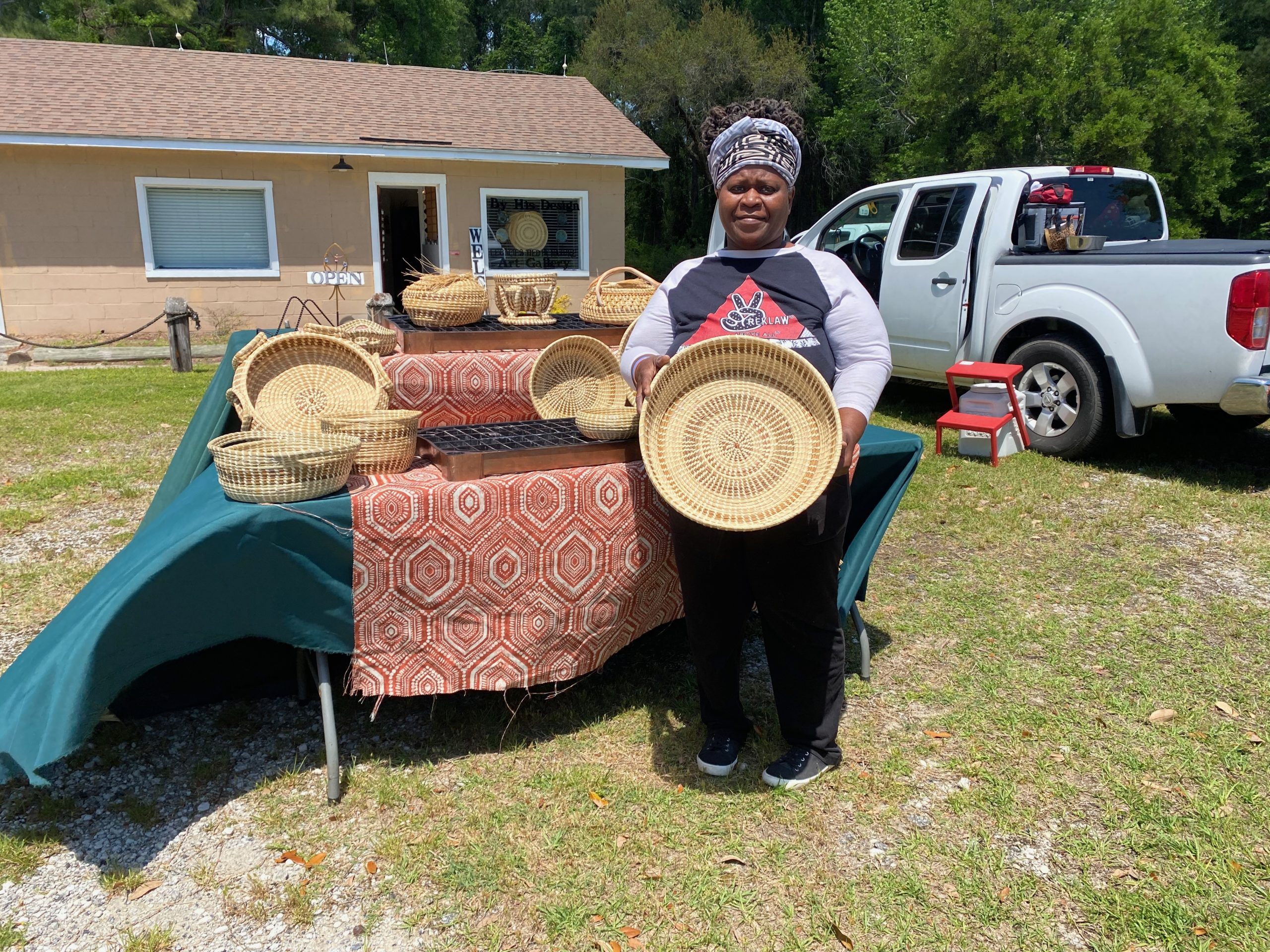 Georgette Sanders holding one of her many baskets